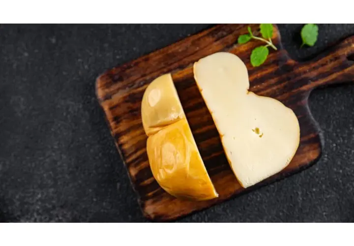 Scamorza affumicata su tagliere di legno, perfetta per una mamma in gravidanza che cerca un sapore autentico e sicuro.