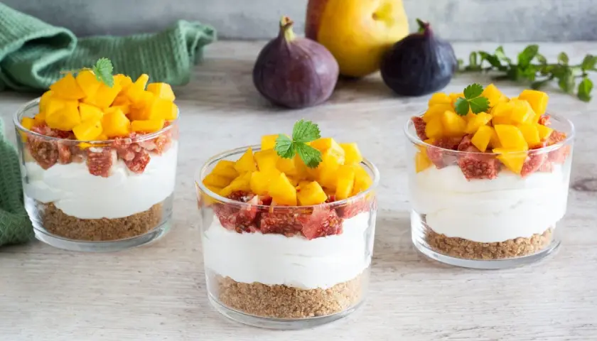 Deliziosi bicchieri con ricotta mousse, crumble, fichi e mango fresco. Un dolce estivo perfetto.