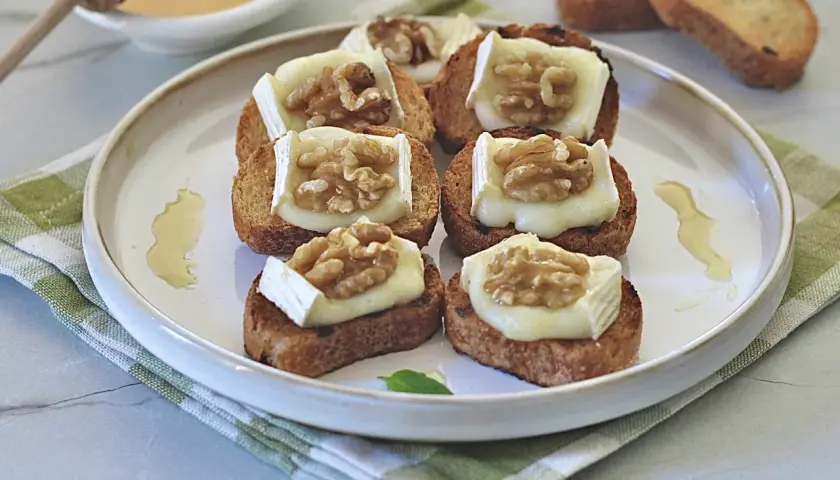 Deliziosi crostini con formaggio fuso e noci, un antipasto perfetto per ogni occasione.