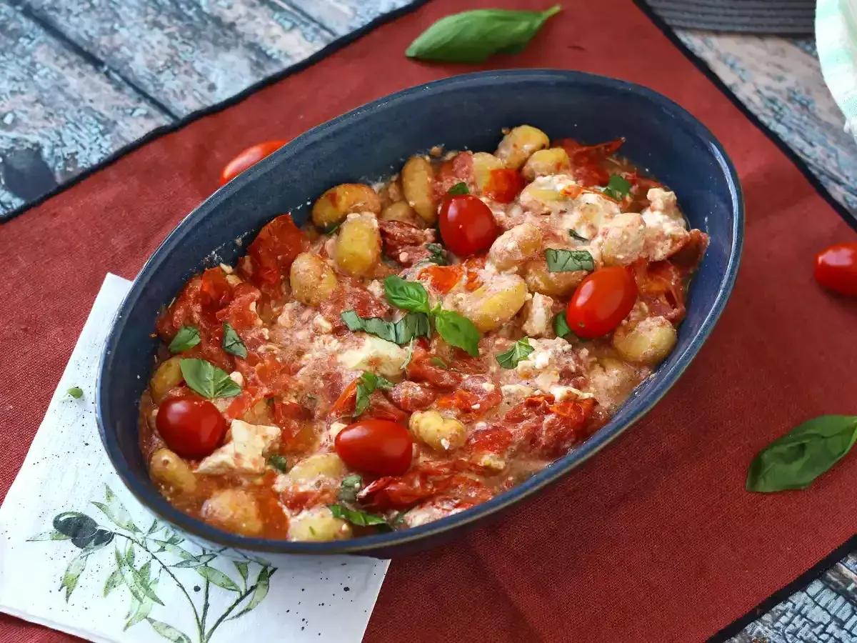Gnocchi al forno con pomodorini e formaggio cremoso, un'ottima alternativa per chi cerca come sostituire la feta in una ricetta mediterranea.