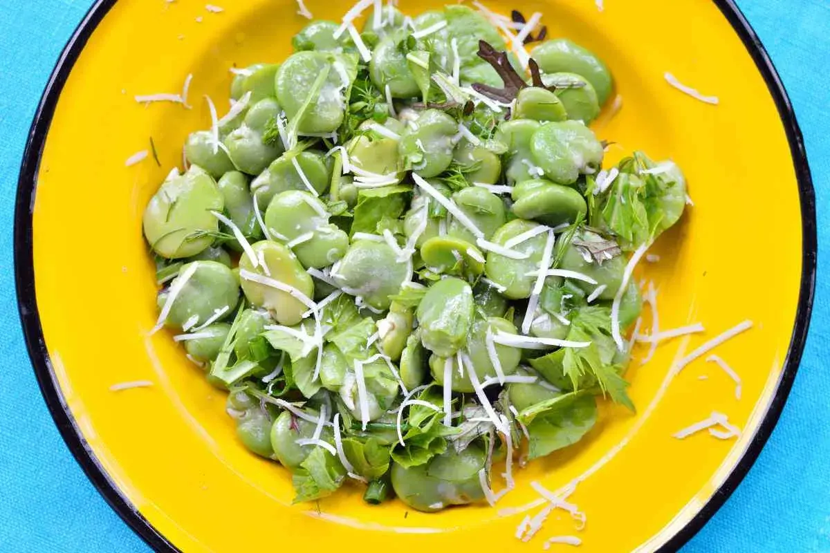 Fave fresche e ricotta grattugiata, un piatto primaverile colorato e gustoso.