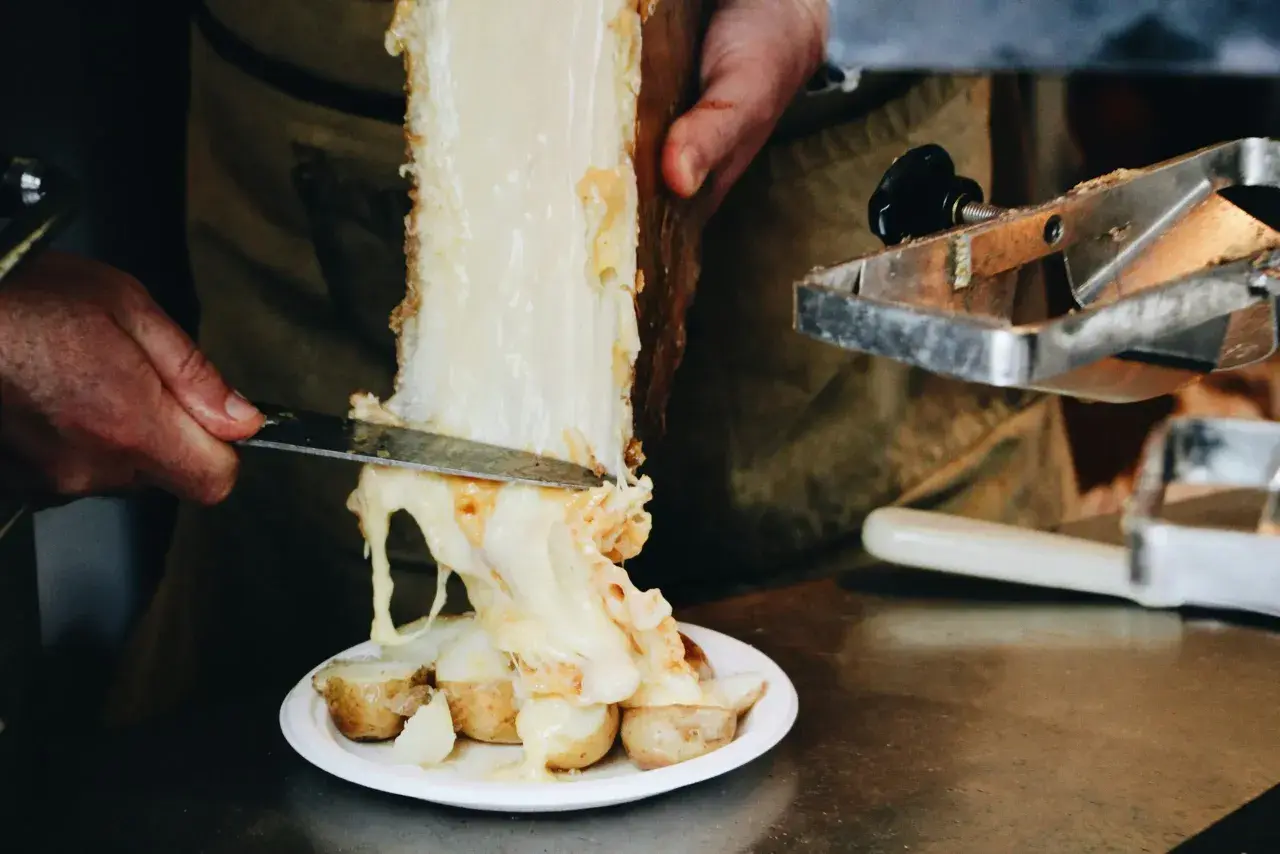 Formaggio per raclette alternativa, fuso e filante, viene raschiato da un grosso pezzo su patate bollite.